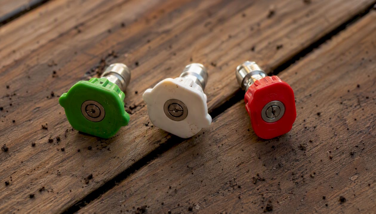 Pressure washer nozzles laid out on concrete