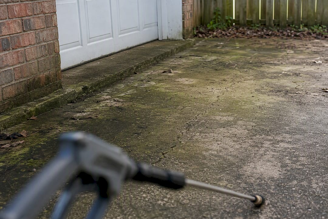 Close-up of heavily stained driveway corner