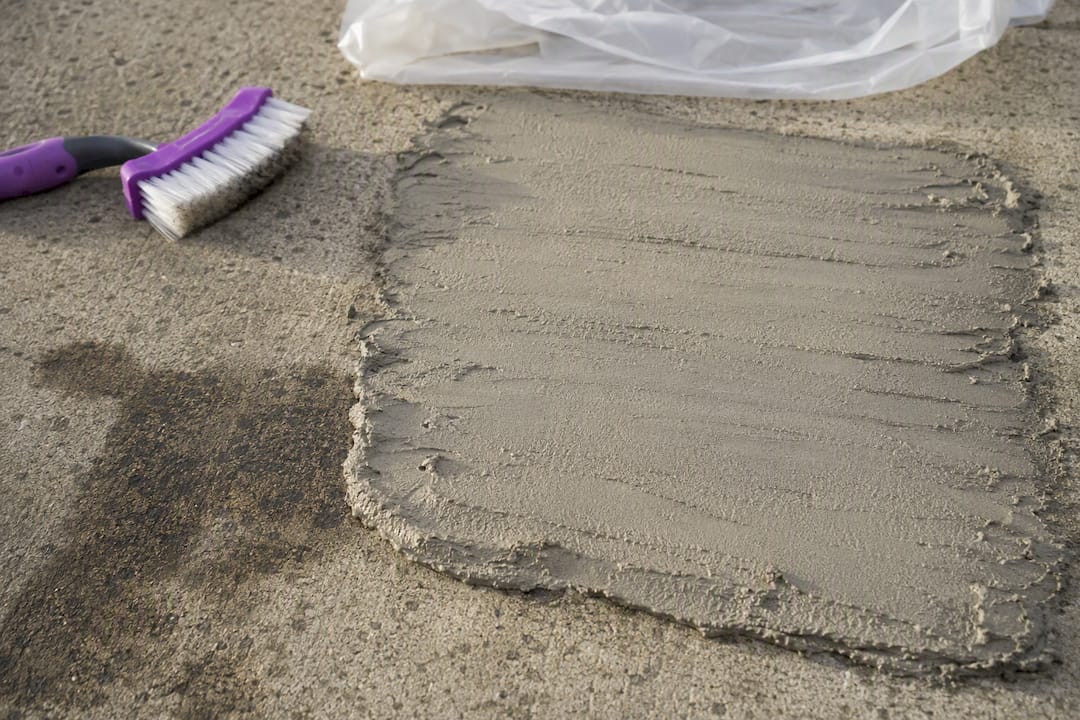 Poultice paste covering an old concrete oil stain