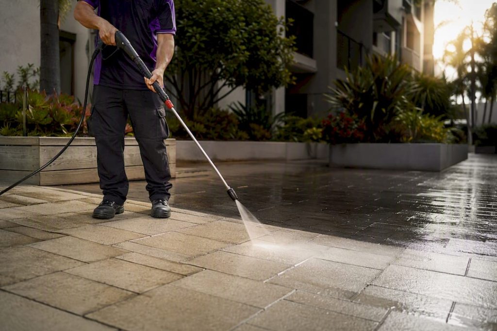 Professional cleaning a paver patio