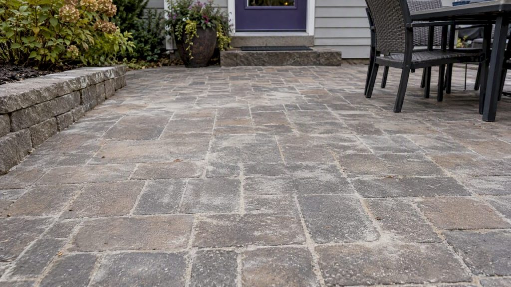 Cloudy polymeric sand haze across patio pavers